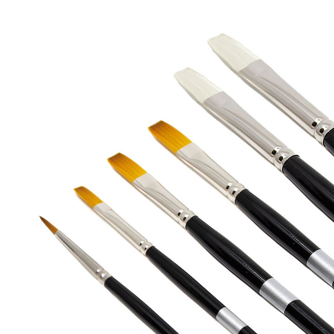 Black-handled brushes fanned diagonally, showing pale and golden flat tips.