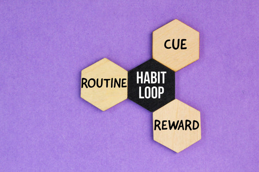 Four linked hexagonal tiles labeled Routine, Habit Loop, Cue and Reward on a purple background.