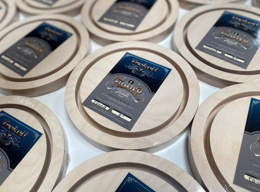 Round unpainted panels with dark Trekell labels stacked together.
