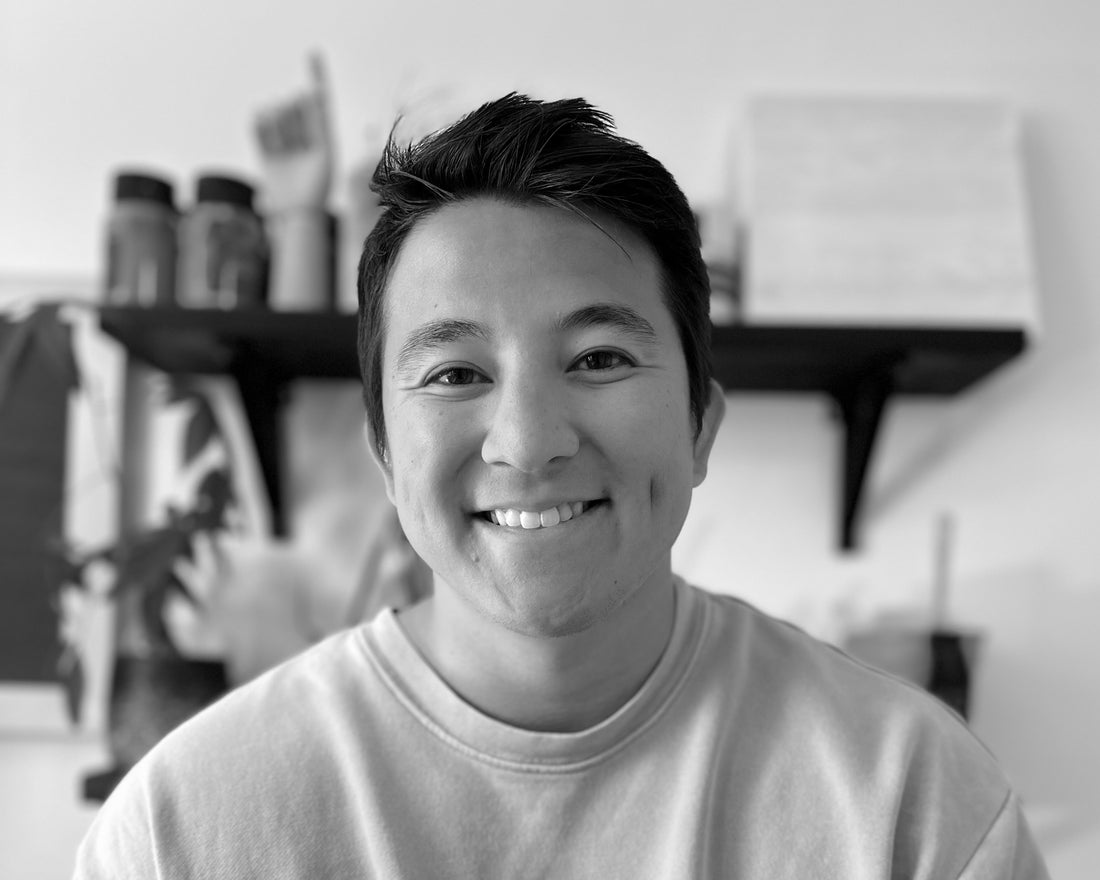 Smiling man in a black-and-white head-and-shoulders portrait.