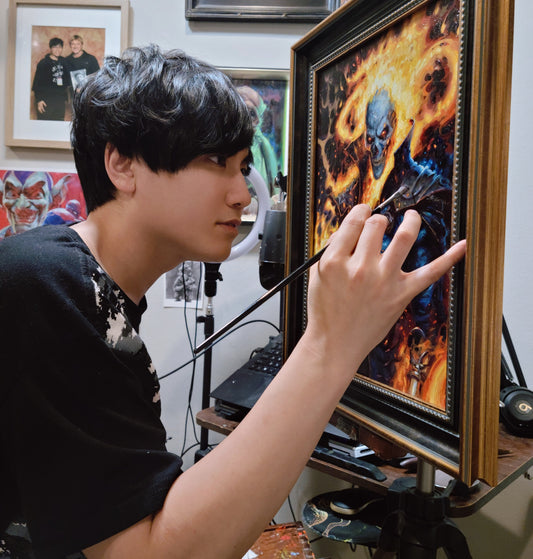 Artist adds detail to a colorful painting in an ornate gold frame.