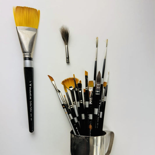 Large golden wash brush, dark mop brush and a jar of assorted brushes.
