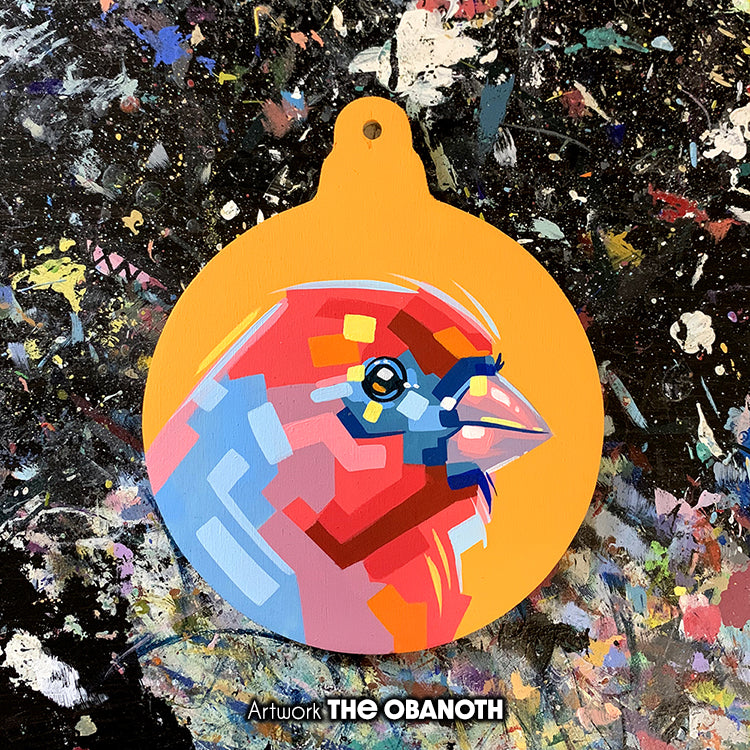 Faceted red-and-blue bird painted on a yellow round ornament panel.