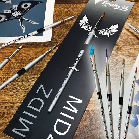 Black MIDZ brush packaging beside fine brushes on a wooden surface.