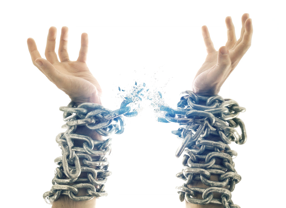 Two raised hands above wrists wrapped in tangled cords.