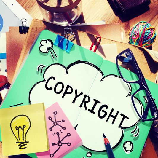Copyright lettering in a cloud shape over a collage of papers and art supplies.