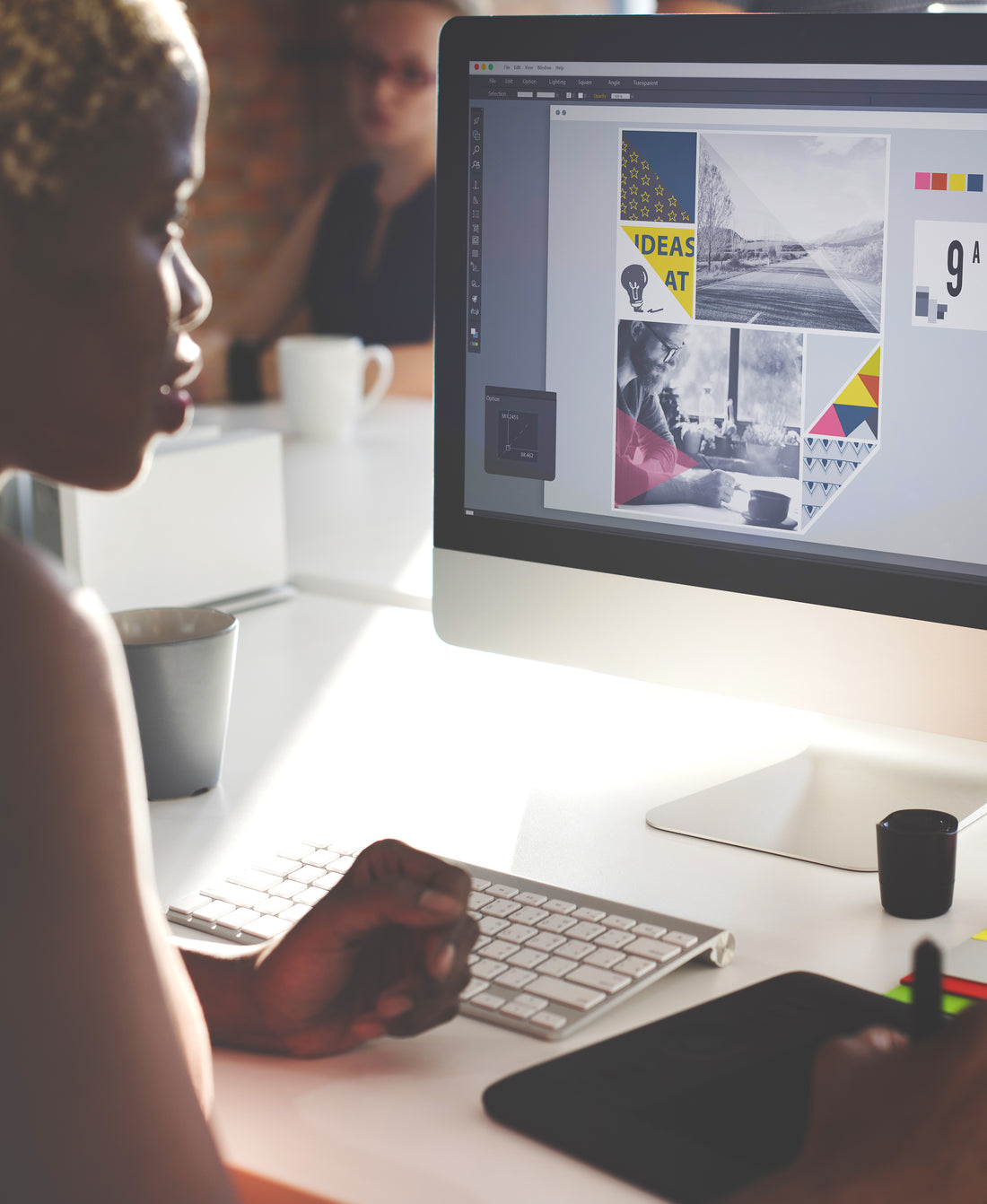 Person works on a digital image at a desktop computer.
