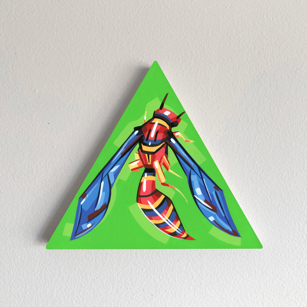 Red-and-yellow winged insect painted on a green triangular panel.