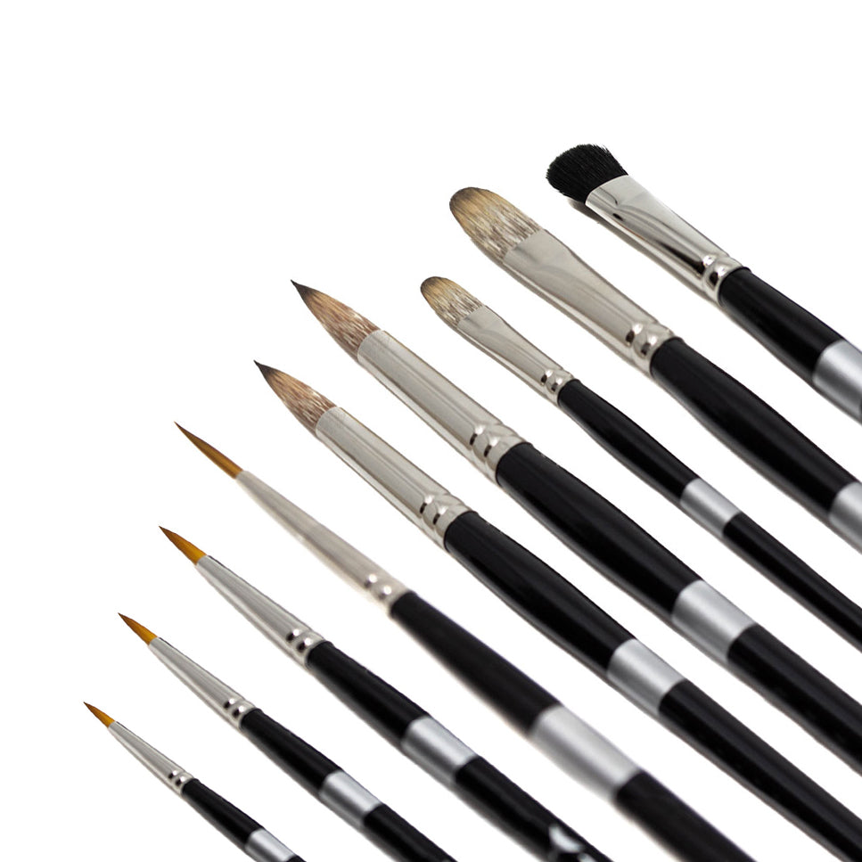 Tony Curanaj brush set, nine black-handled brushes with pointed, rounded and flat tips fanned diagonally.