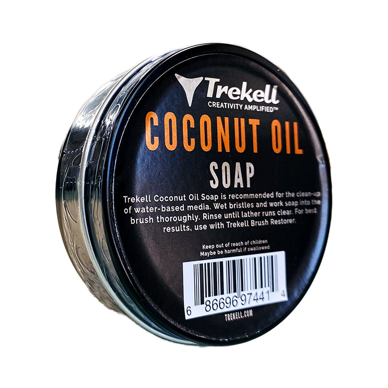 Trekell Coconut Oil Soap tin at an angle, showing a black label and orange lettering.