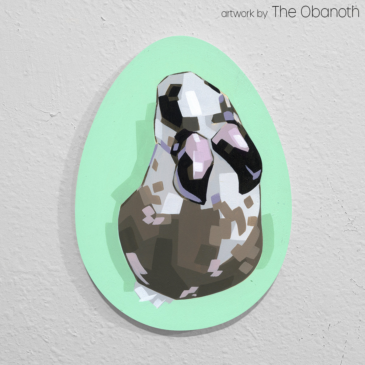 Faceted black, white and gray animal portrait painted on a mint-green egg-shaped panel.