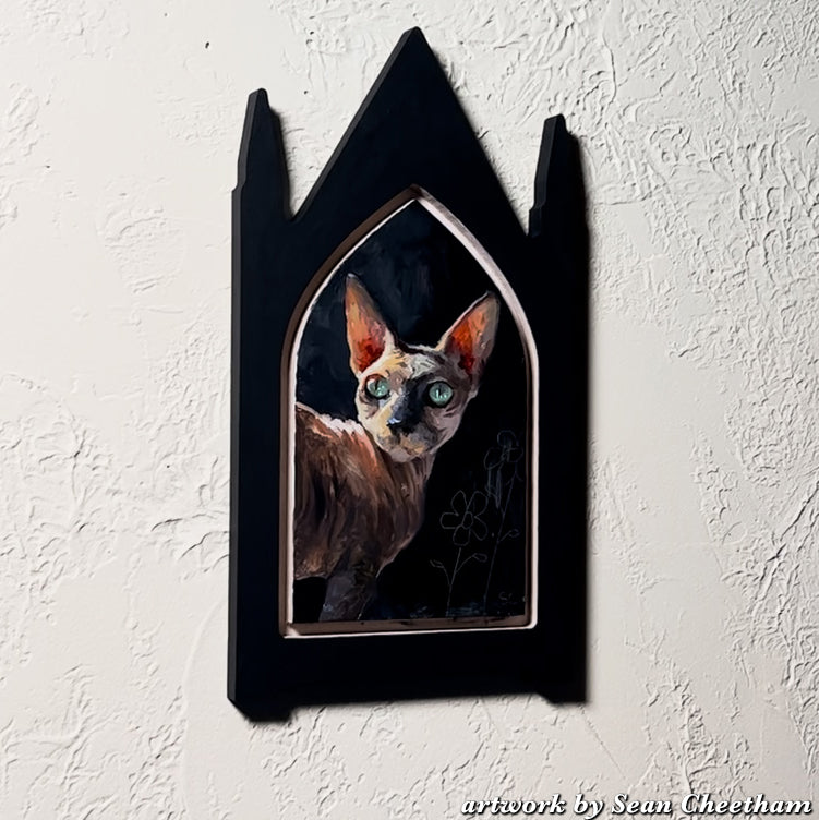 Cat portrait inside a black Gothic Portrait frame with three tall points.