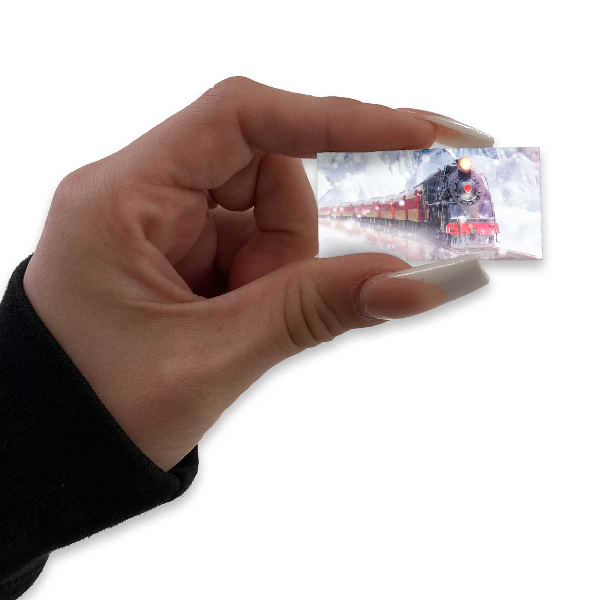 Hand holds a tiny panel painted with a snowy red-roofed building.