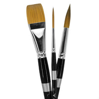 Three black-handled brushes, one broad and flat and two pointed, with golden bristles.