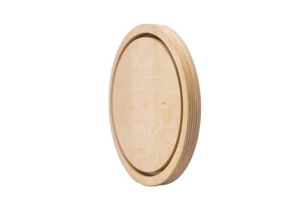 Oval floater panel at an angle, showing its inset center and rounded wooden edge.