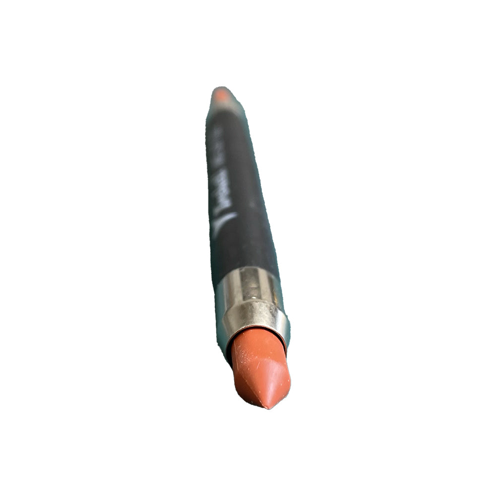 Close-up of the rounded orange end of a dark-handled double-ended brush.