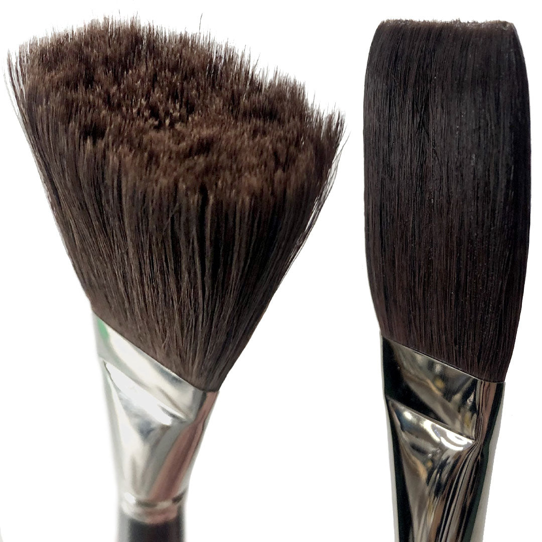 Two broad dark-bristled brushes, one with a splayed worn tip and one with a smooth rounded tip.