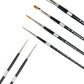 Black-handled brushes fanned diagonally, with pointed and flat golden bristles.