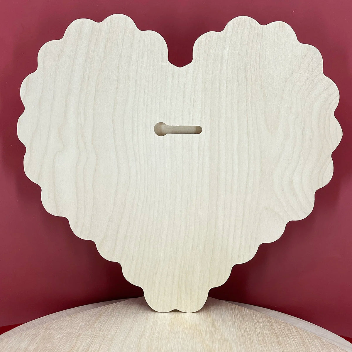 Scalloped heart floater panel, bare wooden back with a horizontal keyhole slot.