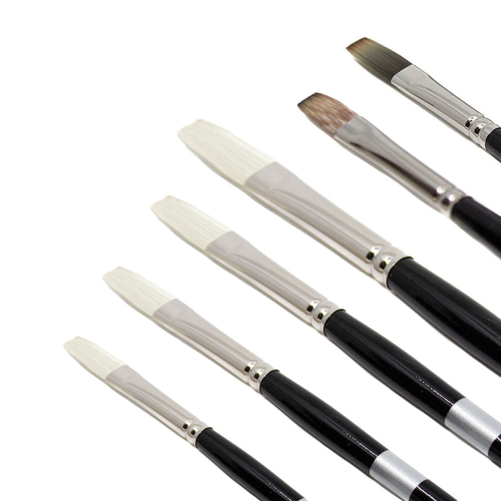 Black-handled flat brushes with pale and brown bristles fanned diagonally.